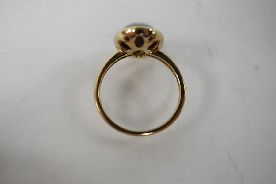 A modern 9ct gold and oval opal triplet set ring, size P/Q, gross weight 4 grams. Condition - good